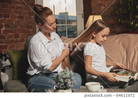 Mother and daughter during self-insulation at home while quarantined, family time cozy and comfort Mother and daughter during self-insulation at home while quarantined, family time cozy and comfort 64611972