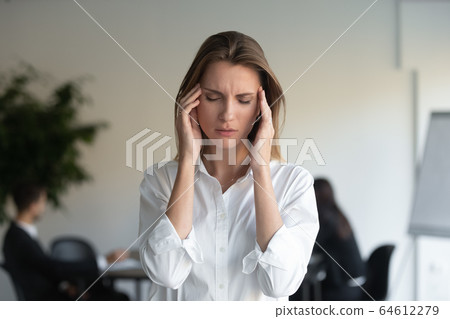 Stressed tired professional business woman feeling headache at work 64612279