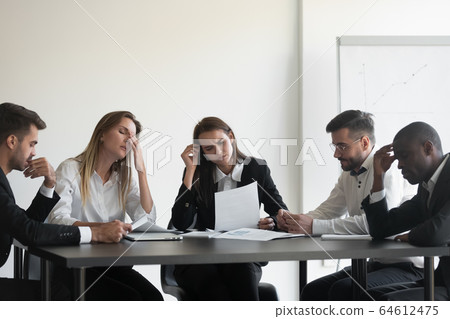 Frustrated multiracial business team people upset with corporate bankruptcy Frustrated multiracial business team people upset with corporate bankruptcy 64612475