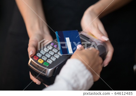 Female customer pay hold credit card use contactless nfc technology Female customer pay hold credit card use contactless nfc technology 64612485