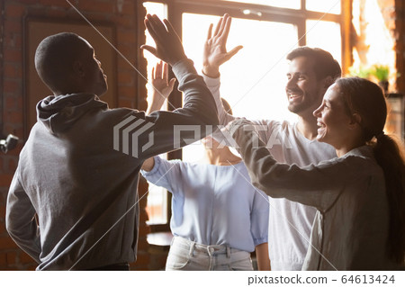Happy diverse friends giving high five engaged in multicultural friendship Happy diverse friends giving high five engaged in multicultural friendship 64613424