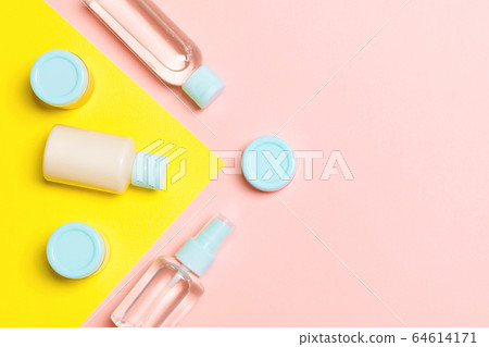 Top view of different cosmetic bottles and Top view of different cosmetic bottles and 64614171