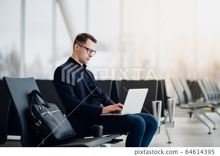 Close up of young freelance business man hands typing on a laptop keyboard while working remotely. Close up of young freelance business man hands typing on a laptop keyboard while working remotely. 64614395