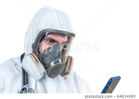 Surgeon man wears a medical mask checks his phone. Surgeon man wears a medical mask checks his phone. 64614993