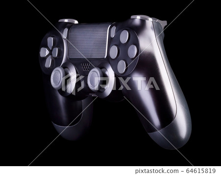 Black video game joystick gamepad isolated on a black background Black video game joystick gamepad isolated on a black background 64615819