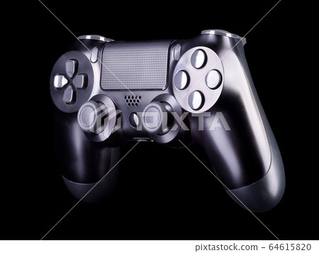Black video game joystick gamepad isolated on a black background Black video game joystick gamepad isolated on a black background 64615820