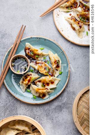 Asian dumplings on blue plate 64616546
