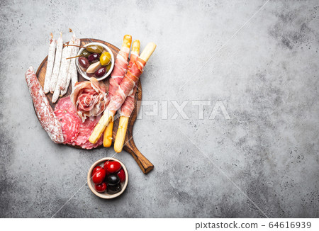Selection of meat and appetizers 64616939