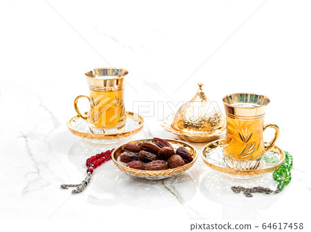 Golden tea cups dates rosary beads decoration 64617458