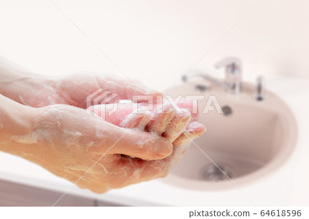 Antibacterial soap in the hands. Hand disinfection with soap.  64618596