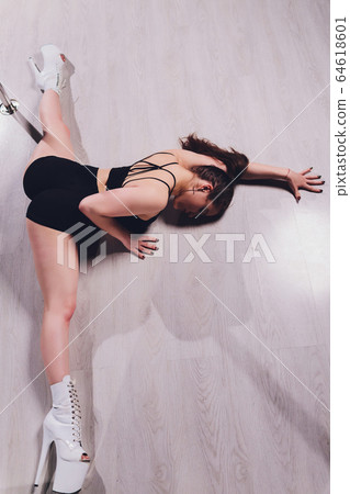 young striptease dancer moving in high heels shoes on stage Pole dancing. 64618601