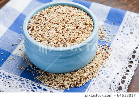 Organic quinoa grains in blue ceramic bowl, Gluten free Organic quinoa grains in blue ceramic bowl, Gluten free 64618817