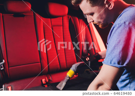 Car interior textile seats chemical cleaning with professionally extraction method. Early spring cleaning or regular clean up. 64619480