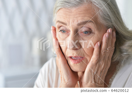 Close up portrait of sad ill senior woman 64620012