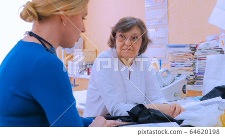 Two tailors discussing new couture collection 64620198