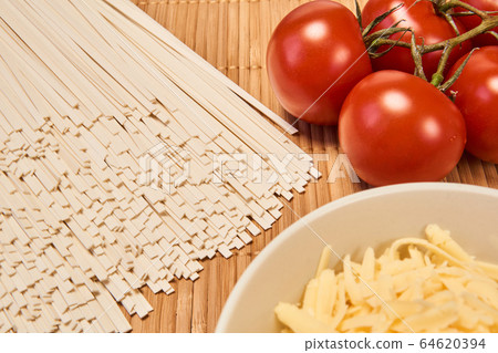 still life with dry udon wheat noodles, tomatoes still life with dry udon wheat noodles, tomatoes 64620394