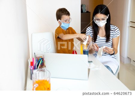 Concentrated young woman playing with her kid Concentrated young woman playing with her kid 64620673