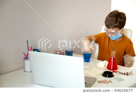 Concentrated little schoolboy playing alone at home Concentrated little schoolboy playing alone at home 64620677