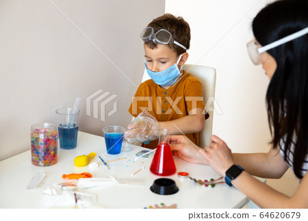 Concentrated little boy playing at home laboratory Concentrated little boy playing at home laboratory 64620679