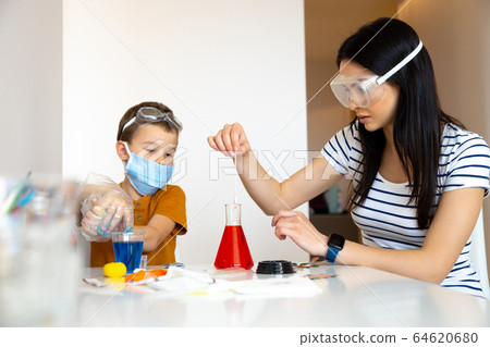 Attentive young brunette taking sample of red water Attentive young brunette taking sample of red water 64620680