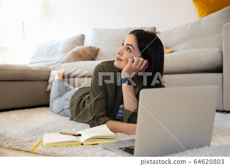 Dreamy lady at home with notes and modern gadget stock photo 64620803