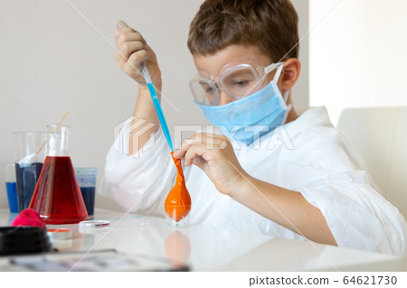 Little boy using home laboratory in free time 64621730