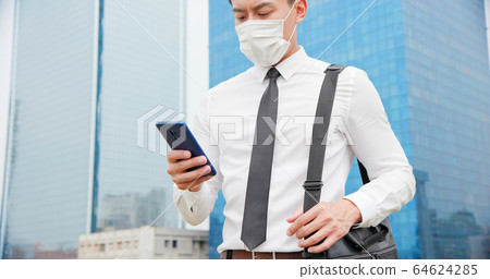 man use smartphone while walking man use smartphone while walking 64624285