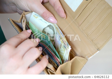 Female hands holding ukrainian hryvnia bills in Female hands holding ukrainian hryvnia bills in 64626112