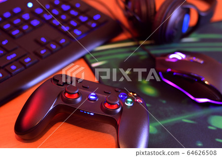 Modern gamepad and gaming mouse lies with keyboard Modern gamepad and gaming mouse lies with keyboard 64626508