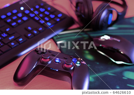 Modern gamepad and gaming mouse lies with keyboard 64626610