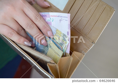 Female hands holding ukrainian hryvnia bills in Female hands holding ukrainian hryvnia bills in 64626646