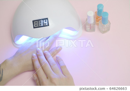 Hands of young woman at manicure procedure close 64626663