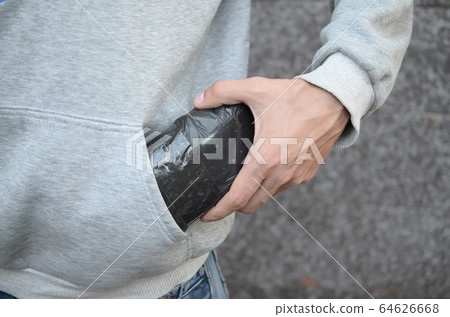 Drug dealer taking bag with cocaine out of hoodie 64626668