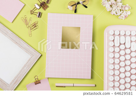 flat lay stationery on work desk in green pastel background 64629581