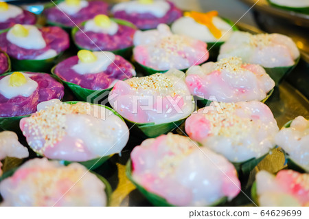 Thailand cup dessert made from Coconut milk topping with white sesame in Banana leaf cup. 64629699