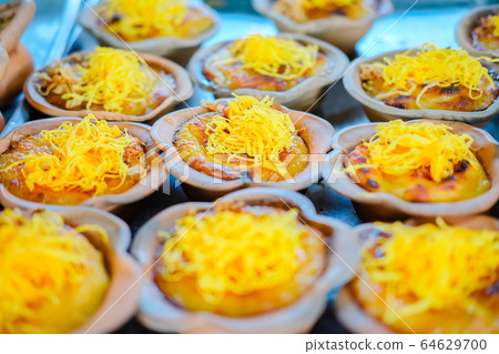 Thailand cup dessert with golden threads (Foi tong) in terracotta cup. 64629700