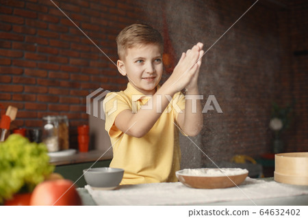 Little boy cook the dough for cookies 64632402