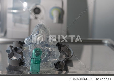 Non-invasive ventilation face mask, on background medical ventilator 64633654