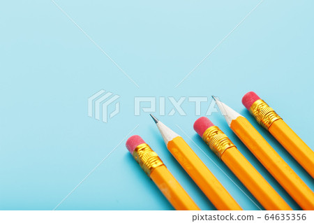 Orange pencils with an eraser on a blue Orange pencils with an eraser on a blue 64635356