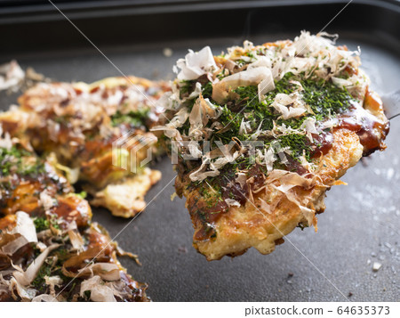 Okonomiyaki on a hot plate Okonomiyaki on a hot plate 64635373