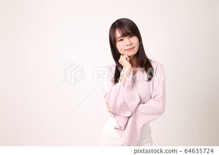 Woman putting hands on face Woman putting hands on face 64635724
