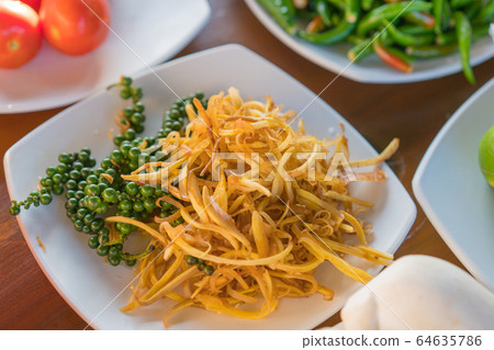 fresh fingerroot slice and green peppercorns chili pepper on table ready to cook a Thai food 64635786