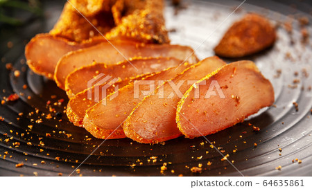 Seasoned chicken with hot sauce and a sprig of rosemary Seasoned chicken with hot sauce and a sprig of rosemary 64635861
