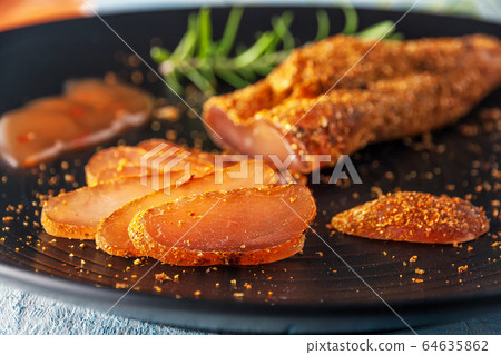 Seasoned chicken with hot sauce and a sprig of rosemary Seasoned chicken with hot sauce and a sprig of rosemary 64635862
