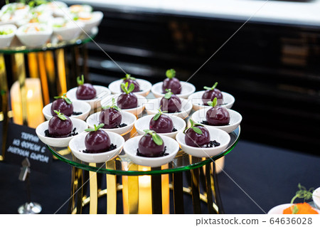 A tray of food on the table. Snack for buffet . Appetizer for a buffet A tray of food on the table. Snack for buffet . Appetizer for a buffet 64636028