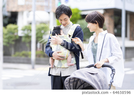 Parents taking a walk with their 3 month old baby Parents taking a walk with their 3 month old baby 64638596