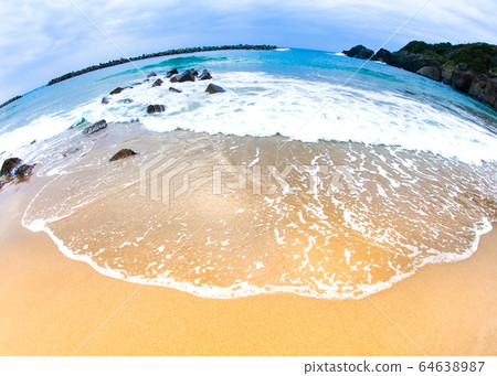 It is a landscape of sandy beach and waves on Sanin coast. The shape of the waves on the beach remains. Please put the text in the bottom margin. 64638987