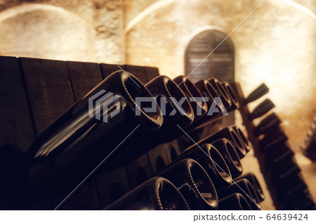 Pupitre and wine bottles in an underground cellar Pupitre and wine bottles in an underground cellar 64639424