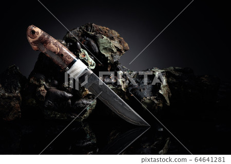 Hunter combat hand made knife and broken stones. Hunter combat hand made knife and broken stones. 64641281