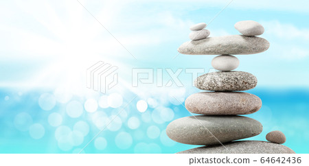 Pyramid of sea pebbles on a sunny beach Pyramid of sea pebbles on a sunny beach 64642436